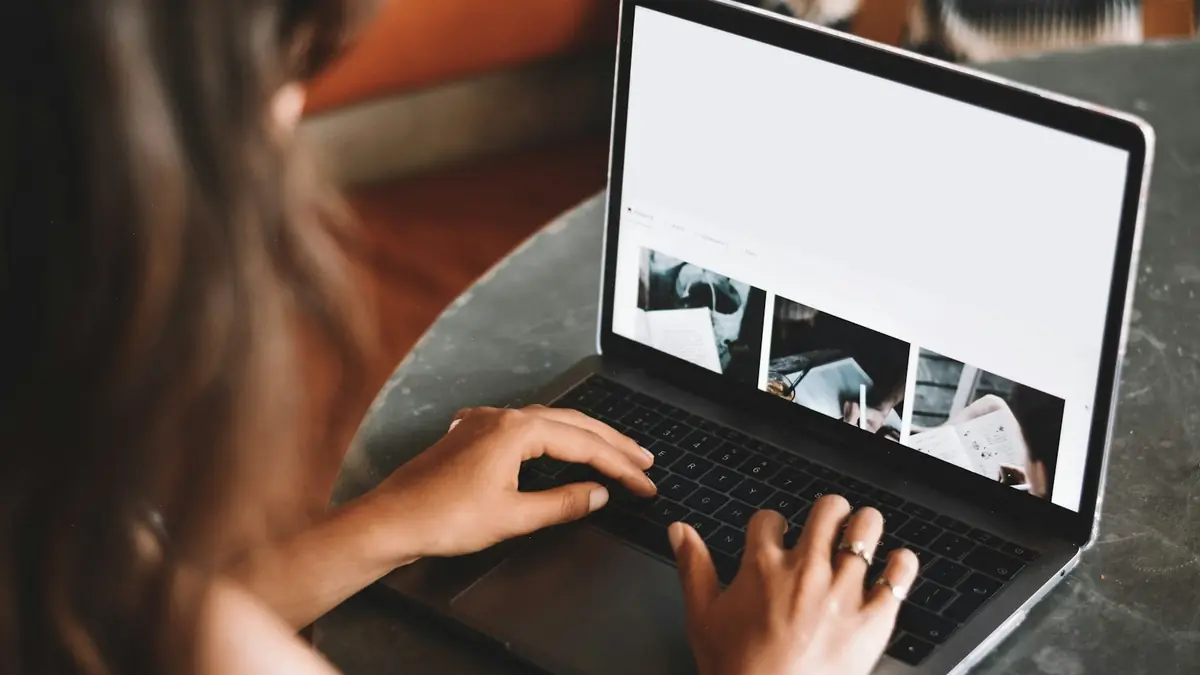 Person working on a laptop at a desk