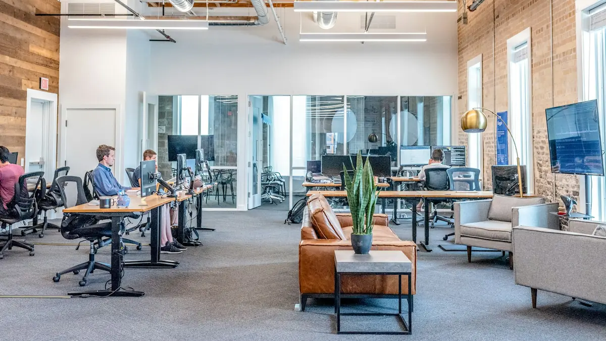 Developer working at a desk with multiple monitors in a modern office