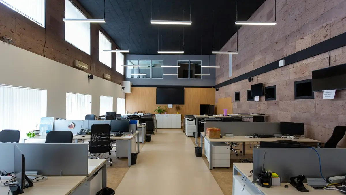 Open-plan office with rows of desks and computers